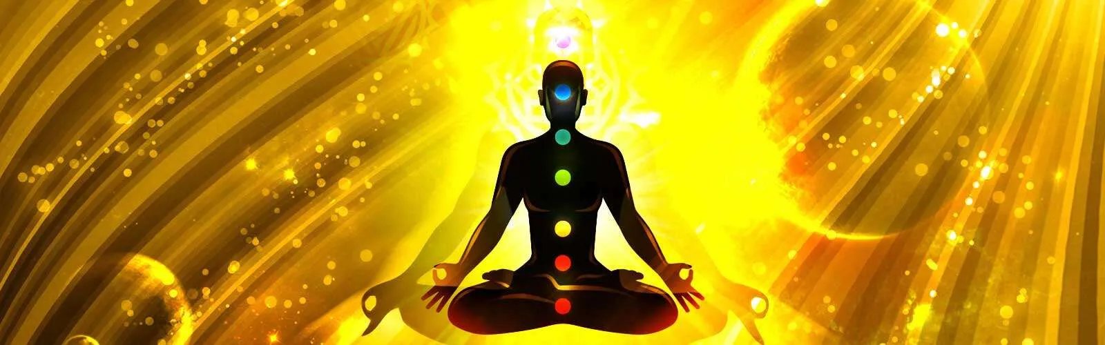 A person sitting in the lotus position with seven colored chakras.